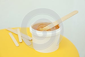 Liquid yellow paste for shugaring on yellow background