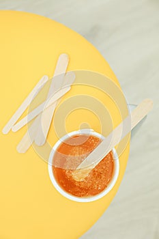 Liquid yellow paste for shugaring on yellow background