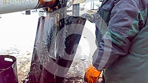 Liquidation of the oil spill. Locksmiths are engaged in eliminating oil leakage and repairing equipment. Workers liquidate the oil