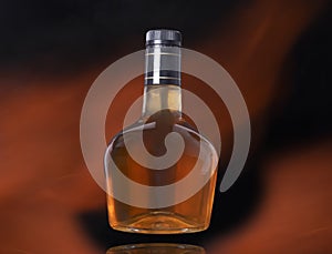 Liquor bottle on black background with fire