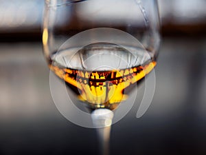 Liquor bottles reflected in whisky filled wine glass, Kyoto, Japan