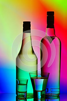 Liquor bottles and shot glasses photo