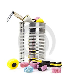Liquorice allsorts in a tin isolated on white background