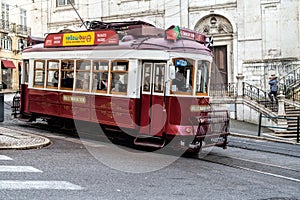 Touristic electric tram in a street of downtown Lisbon, Portugal