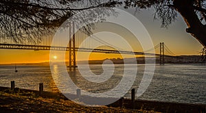 Lisbon Bridge Over tagus river sunset seen from Almada photo