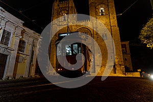 Lisbon cathedral night view with tram