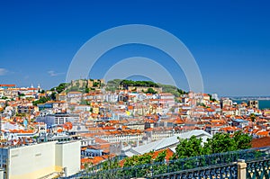 Lisbon cityscape, aerial panoramic view of Lisboa historical city centre with colorful buildings red tiled roofs, Sao Jorge Castle