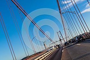 Lisbon, Portugal. Cars crossing or driving through the 25 de Abril suspension bridge photo