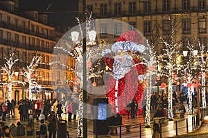 Lisbon, Portugal - 12/26/18: Giant Santa statue in the middle of the street in Baixa Chiado