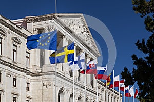 Detail of the facade of the Assembleia da Republica Portuguese Parliament, with the European union countries flags raised in ord