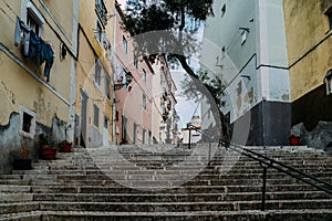 Lisbon, Portugal. Stone stairs with railings among colourful old houses in Alfama district