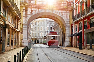 Lisbon Portugal. Vintage red retro tram on narrow bystreet