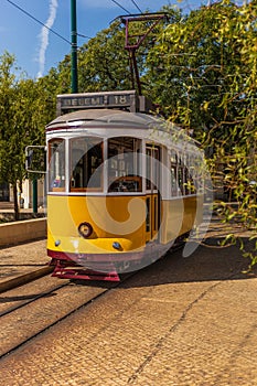 Lisbon`s famous yellow tram on a sunny day