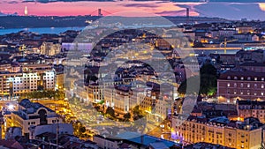 Lisbon after sunset aerial panorama view of city centre with red roofs at Autumn day to night timelapse, Portugal