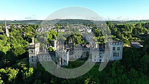 Lismore Castle against the backdrop of green trees and mountains in 4k