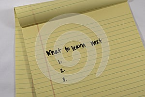 A list of three blank reasons and the text of What to learn next on a yellow legal pad