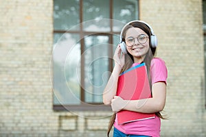 Listen for education you want. Happy child wear headphones outdoors. Listen technologies. Listening comprehension