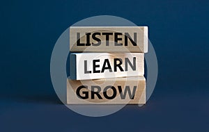 Listen, learn and grow symbol. Wooden blocks with concept words listen, learn, grow. Beautiful grey background, copy space.