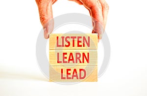 Listen learn lead symbol. Concept word Listen Learn Lead on beautiful wooden block. Businessman hand. Beautiful white table white