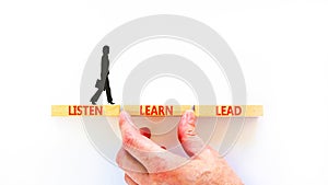 Listen learn lead symbol. Concept word Listen Learn Lead on beautiful wooden block. Businesswoman icon. Beautiful white table