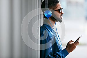 Listen Music. Man With Headphones And Phone In Fashion Clothes