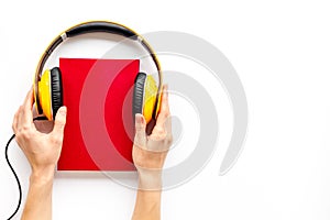 Listen to audio books with headphone in hands on white background flatlay mock up