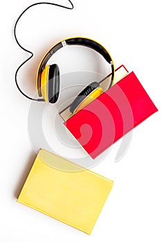 Listen to audio books with headphone on white background flatlay