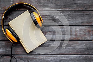 Listen to audio books with headphone on wooden background flatlay mock up