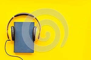 Listen to audio books with headphone on yellow background flatlay mock up