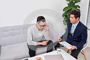 Listen to me. Asian man wrinkling forehead while looking at his therapist photo