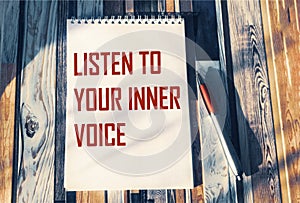 Listen to your inner voice - inspiring phrase on a notebook. Confidence, intuition