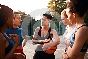 Listening is part of the game. a diverse group of friends getting ready to play a game of basketball together during the