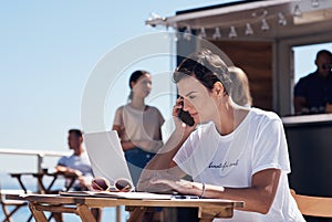 Listening, phone call and woman with laptop, outdoor and restaurant in morning for scriptwriter with sunglasses. Summer photo