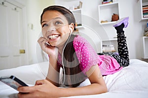 Listening to her music brings back good memories. a teenage girl listening to music in her bedroom.