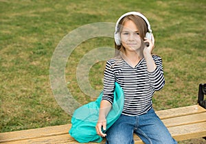 Listening to new tunes. Small kid listen to music summer outdoors. Listening comprehension. Audio learning. English