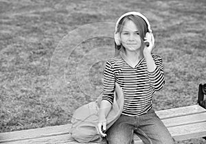 Listening to new tunes. Small kid listen to music summer outdoors. Listening comprehension. Audio learning. English