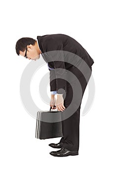 Listless businessman stoop and holding briefcase photo