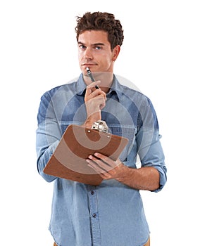 Lists make everything easier. A pensive young man holding a clipboard.