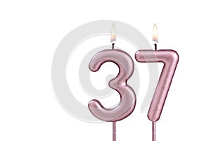 Lit birthday candle - Candle number 37 on white background