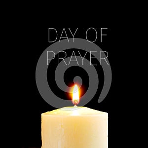 Lit candle and text day of prayer