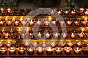 Lit candles in a Catholic Church of Santiago de Compostela, Galicia, Spain.