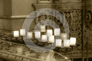 Lit candles inside a church, detail photo