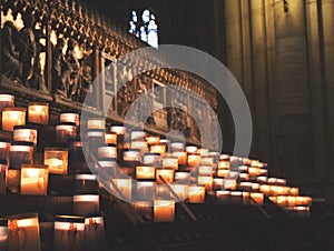 Lit Candles inside church Notre Dame de Paris, France