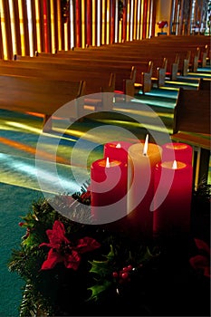 Lit Christmas Candles and Wreath in Empty Church