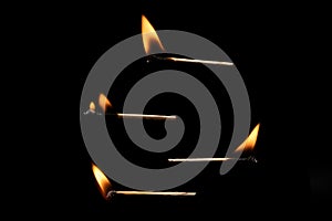 Lit falling match on a black background