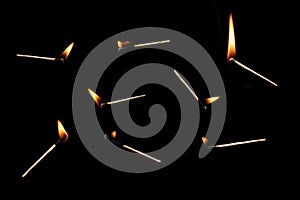 Lit falling match on a black background