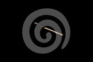 Lit falling match on a black background