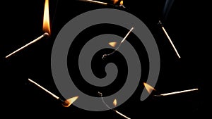 Lit falling match on a black background