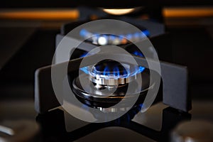 Lit gas burner on a glass plate closeup