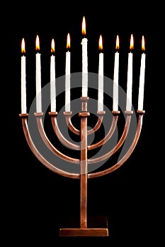 Lit hanukkah menorah black background.